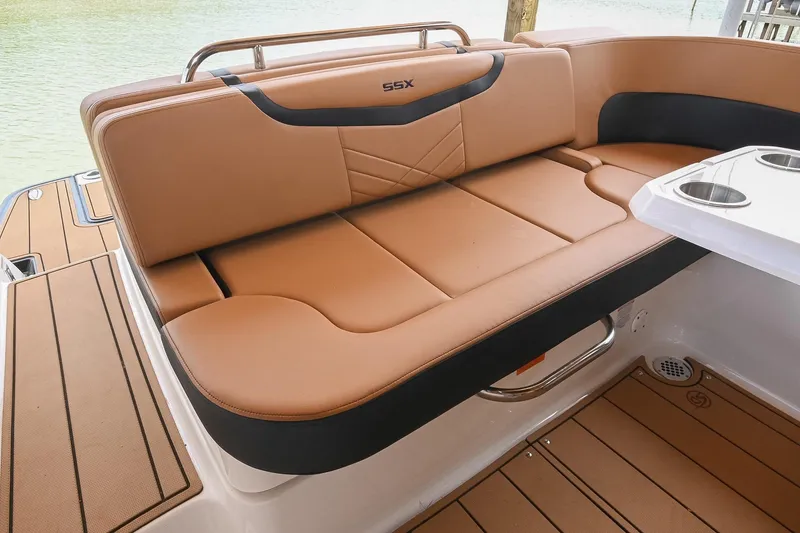 Slide: The Image of 2022 Chaparral 307 SSX boat interior with tan seating and cup holders. - 19