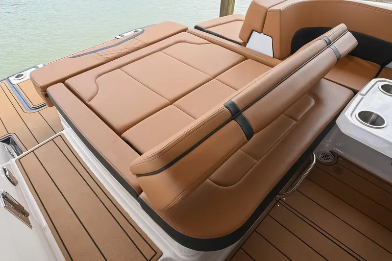 Slide: The Image of 2022 Chaparral 307 SSX boat with luxurious tan seating and cup holders. - 20