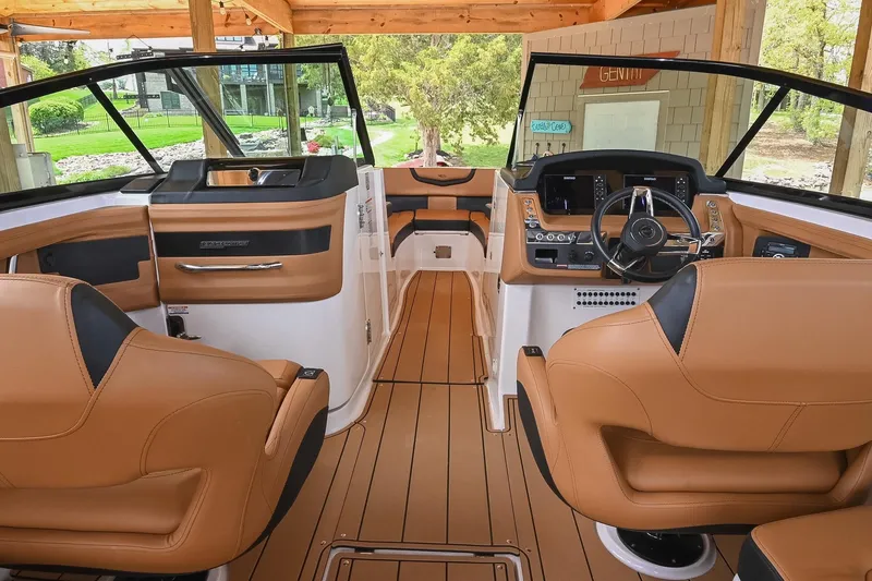 Slide: The Image of 2022 Chaparral 307 SSX boat interior with luxurious tan leather seating and modern dashboard. - 23