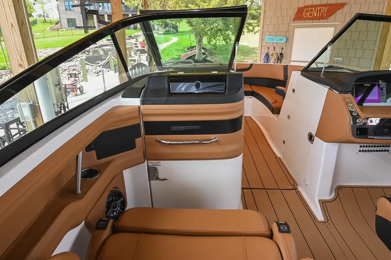 Slide: The Image of 2022 Chaparral 307 SSX boat interior with luxurious seating and modern dashboard. - 25