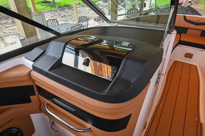 Slide: The Image of 2022 Chaparral 307 SSX boat interior with sleek dashboard and luxurious seating. - 26