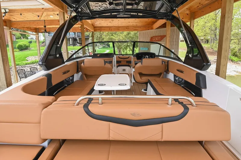 Slide: The Image of 2022 Chaparral 307 SSX boat interior with tan seating and modern design. - 3
