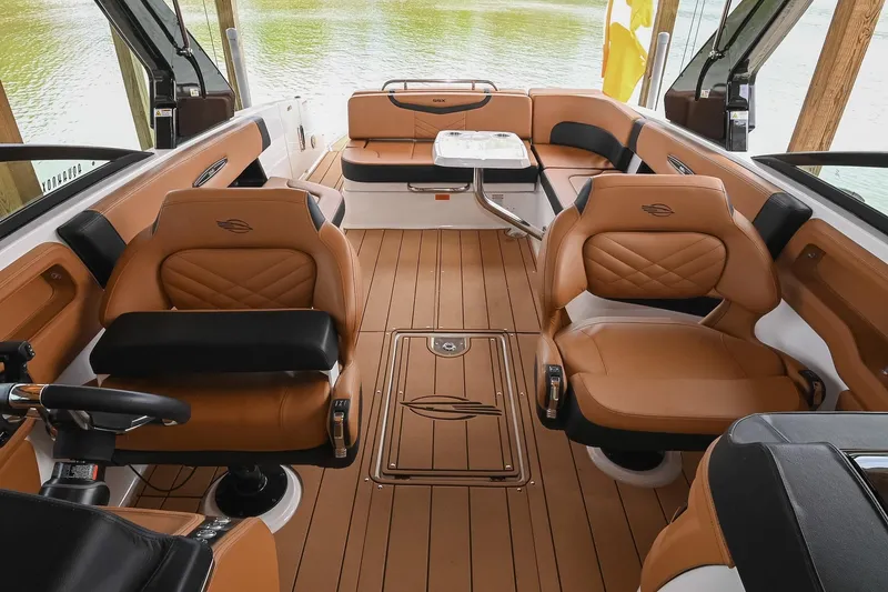 Slide: The Image of Luxurious interior of 2022 Chaparral 307 SSX boat with tan leather seating and wood flooring. - 30