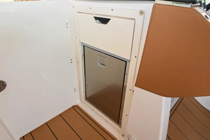 Slide: The Image of 2022 Chaparral 307 SSX boat interior with stainless steel storage compartment. - 32