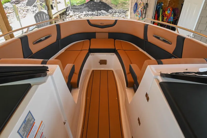 Slide: The Image of 2022 Chaparral 307 SSX boat interior with tan and black seating. - 33