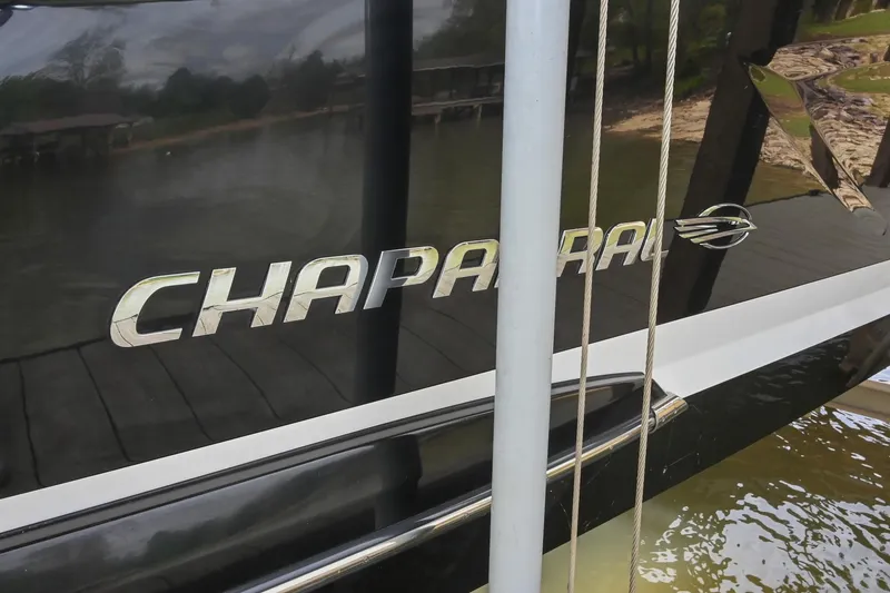 Slide: The Image of 2022 Chaparral 307 SSX boat with logo, docked by the water. - 4