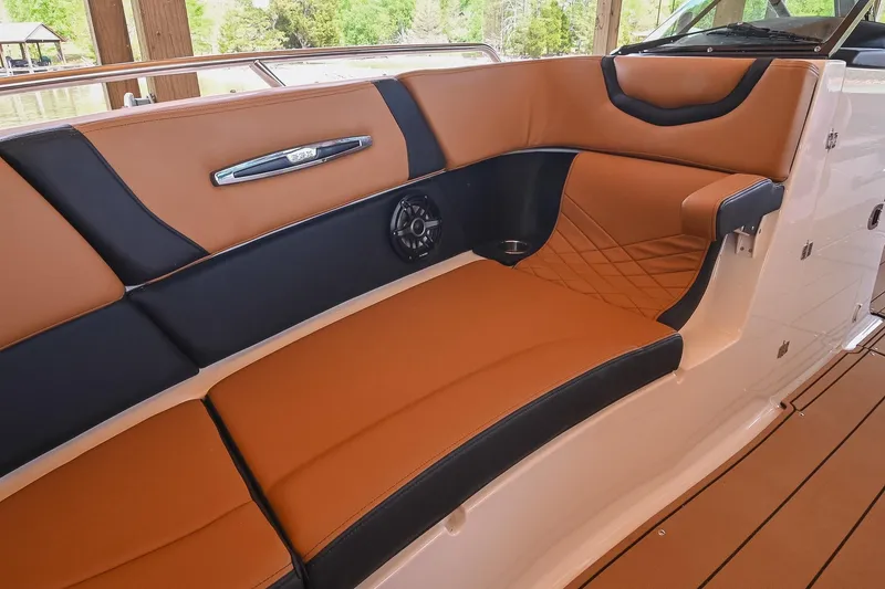 Slide: The Image of Luxurious seating on 2022 Chaparral 307 SSX boat with tan and black upholstery. - 45