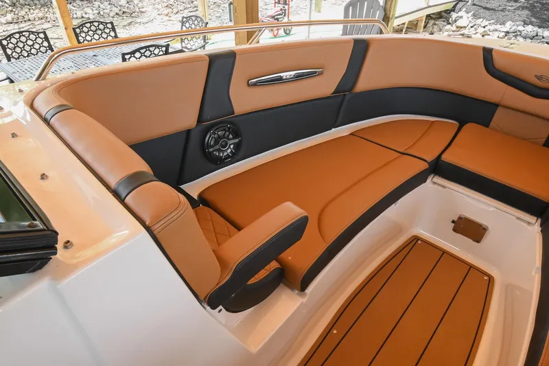 Slide: The Image of 2022 Chaparral 307 SSX boat interior with tan and black seating. - 47