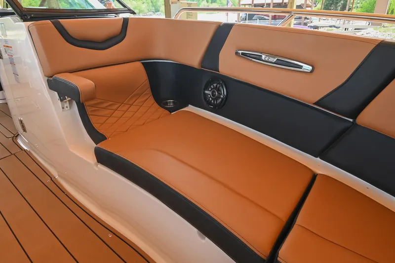 Slide: The Image of Luxurious interior seating of 2022 Chaparral 307 SSX boat with tan and black upholstery. - 48