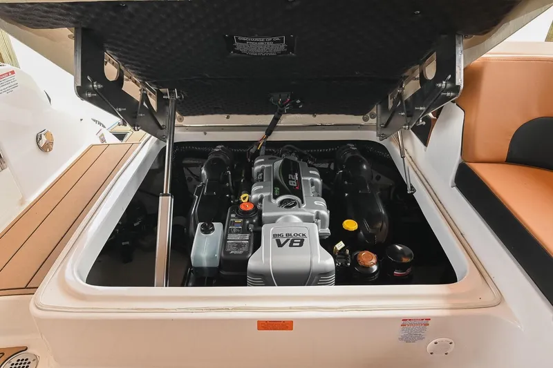 Slide: The Image of 2022 Chaparral 307 SSX boat engine compartment with V8 engine visible. - 49