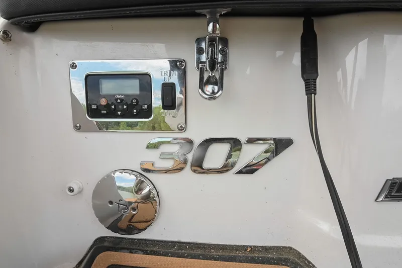 Slide: The Image of 2022 Chaparral 307 SSX boat dashboard with control panel and model emblem. - 5
