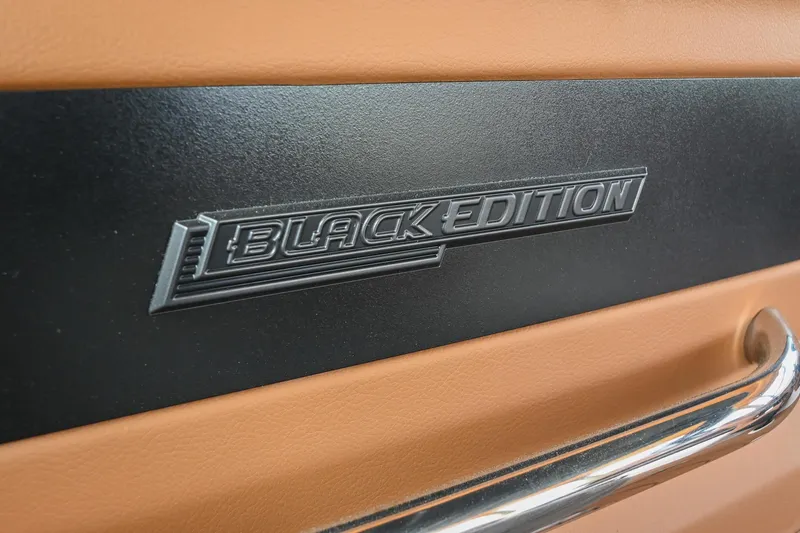 Slide: The Image of 2022 Chaparral 307 SSX Black Edition emblem on tan and black interior. - 7