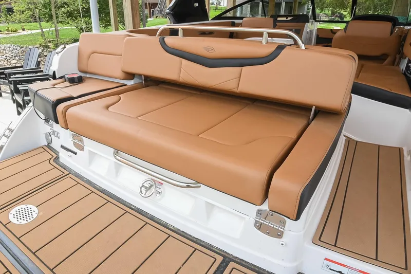 Slide: The Image of 2022 Chaparral 307 SSX boat with luxurious tan seating and sleek design. - 9
