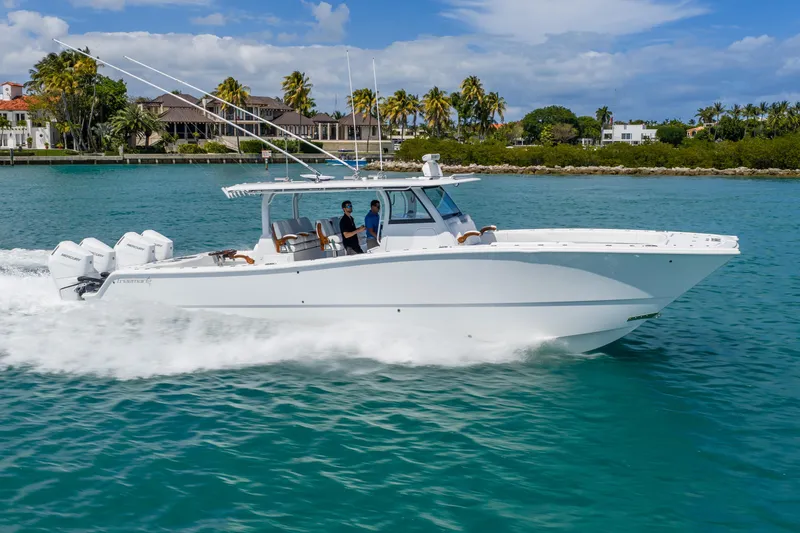 The Image of 2025 Freeman 43 boat cruising on turquoise water near a tropical shoreline. - 0