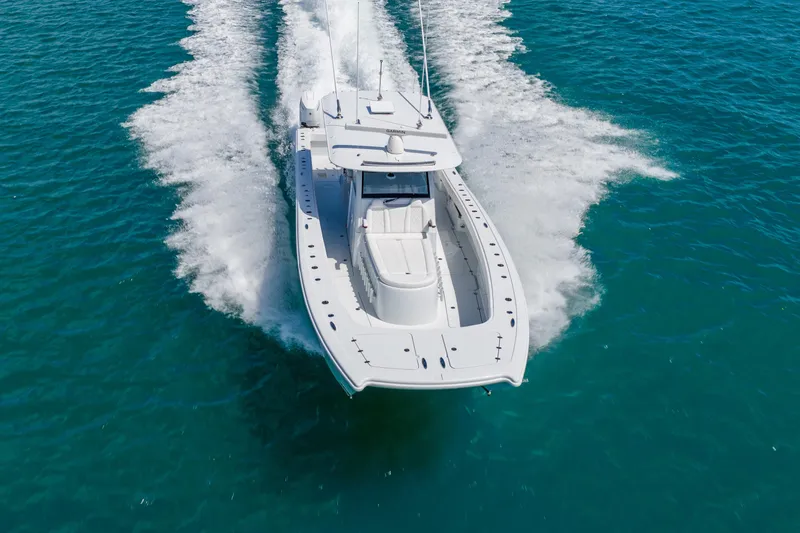 Slide: The Image of 2025 Freeman 43 boat cruising on clear blue water, showcasing sleek design and powerful performance. - 11