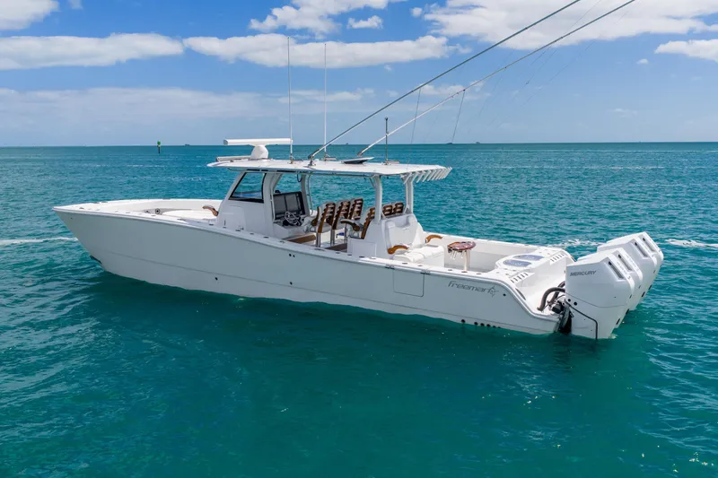 Slide: The Image of 2025 Freeman 43 boat on clear blue ocean under a partly cloudy sky. - 13