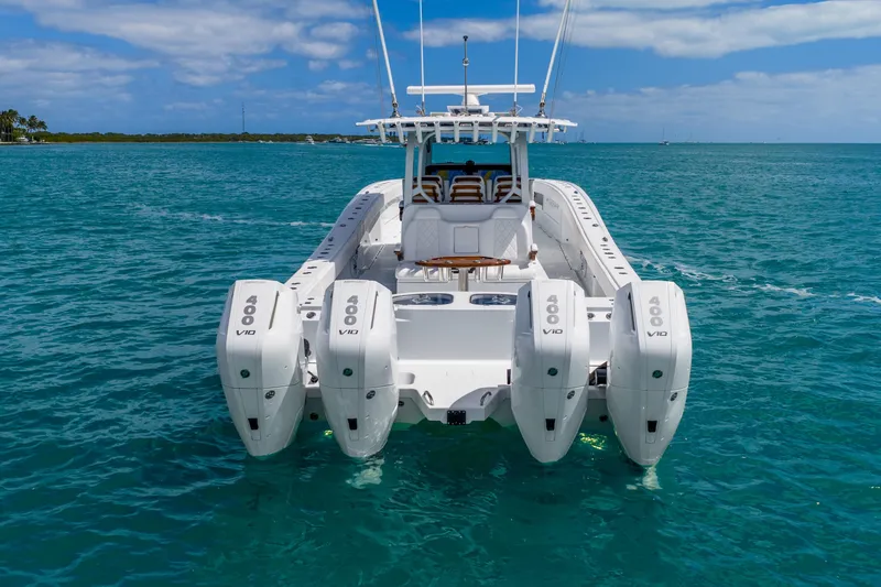 Slide: The Image of Freeman 43 boat, 2025 model, with four powerful V10 engines on turquoise water. - 14