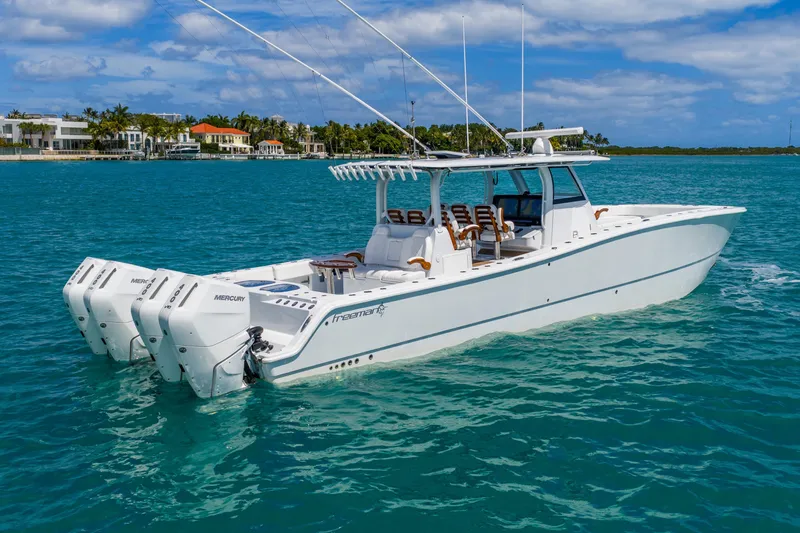 Slide: The Image of 2025 Freeman 43 boat with multiple outboard engines on clear blue water. - 15