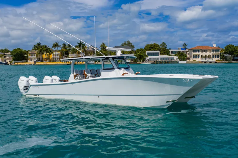 Slide: The Image of 2025 Freeman 43 boat on turquoise water with luxury waterfront homes in the background. - 17