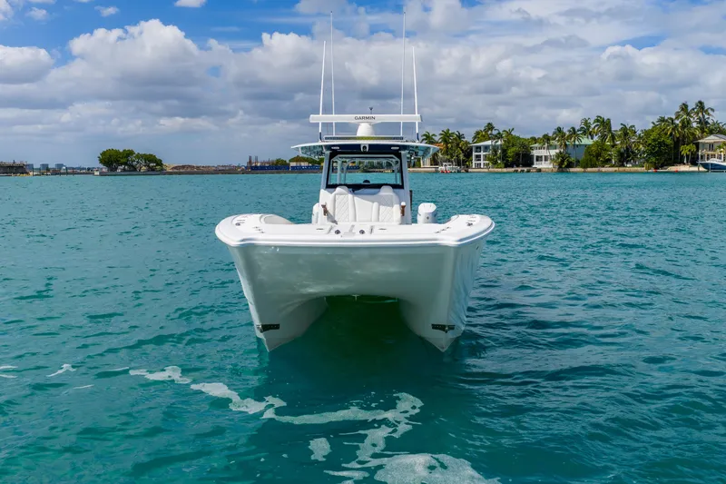 Slide: The Image of 2025 Freeman 43 boat on turquoise water with tropical background and cloudy sky. - 18