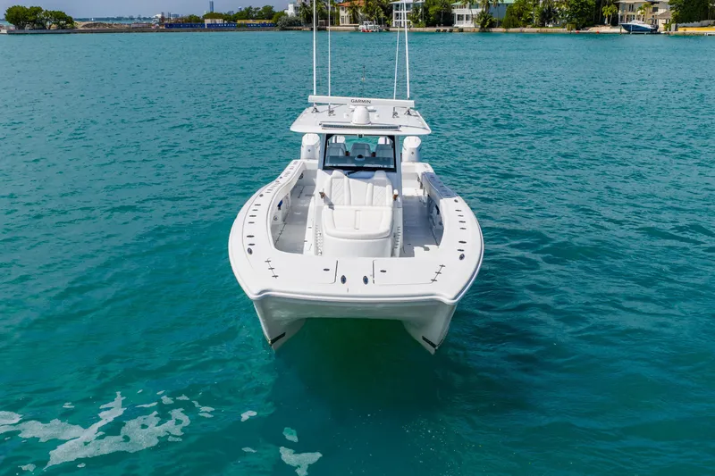 Slide: The Image of 2025 Freeman 43 boat on clear blue water, showcasing sleek design and modern features. - 19