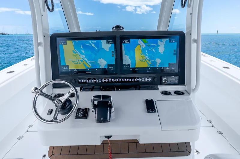 Slide: The Image of Helm of 2025 Freeman 43 boat with dual navigation screens and steering wheel. - 21