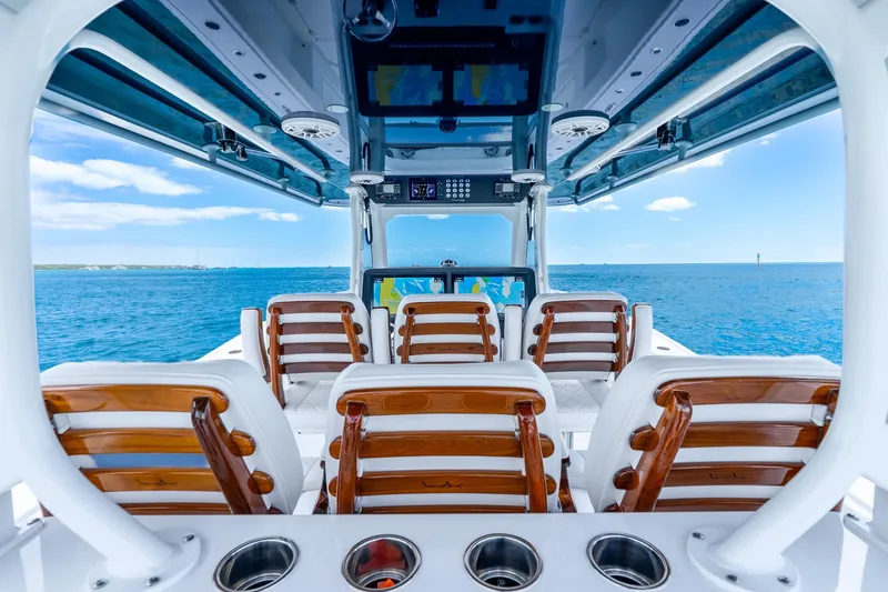 Slide: The Image of Interior view of 2025 Freeman 43 boat with wooden seats and ocean backdrop. - 24