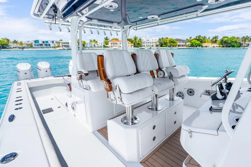 Slide: The Image of Luxurious 2025 Freeman 43 boat interior with plush seating, overlooking serene waterfront homes. - 27
