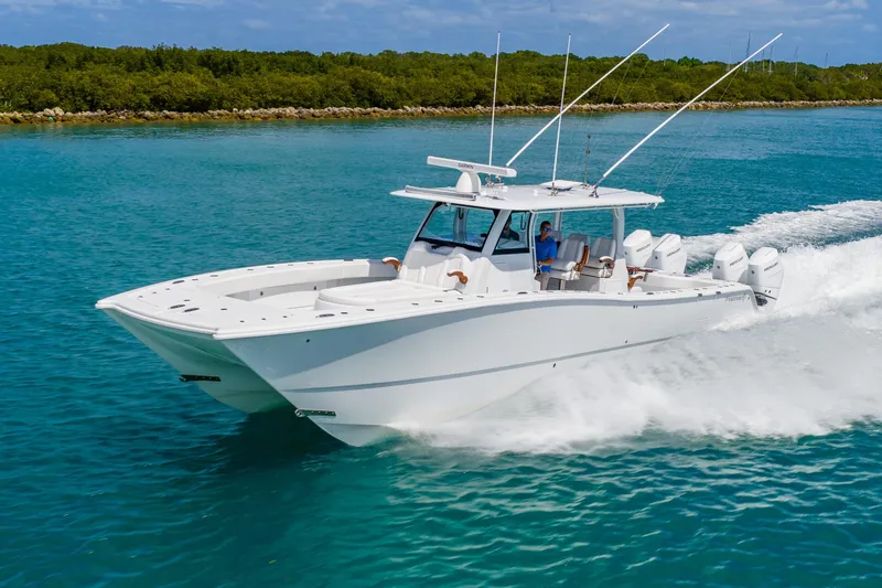 Slide: The Image of 2025 Freeman 43 boat cruising on clear blue water, showcasing sleek design and powerful engines. - 3