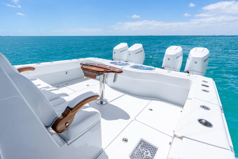 Slide: The Image of Luxury Freeman 43 boat deck with seating, table, and four Mercury engines, 2025 model. - 31