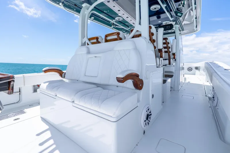 Slide: The Image of Luxurious seating on a 2025 Freeman 43 boat, featuring elegant white upholstery and wooden accents. - 33