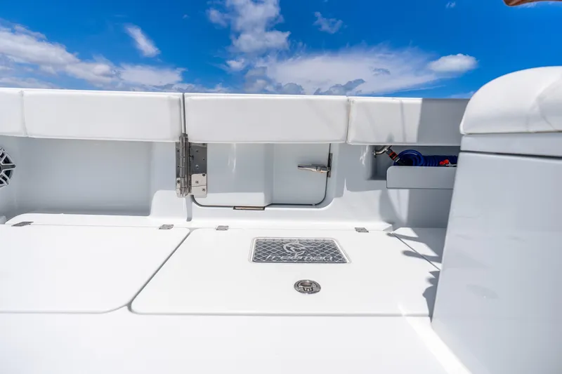 Slide: The Image of 2025 Freeman 43 boat deck with storage compartments under a clear blue sky. - 36