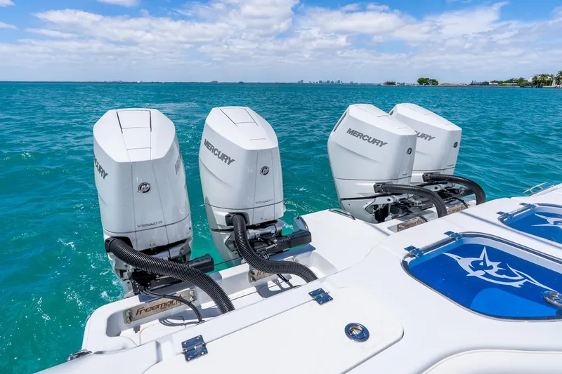 Slide: The Image of Freeman 43 boat with four Mercury outboard engines on turquoise water, 2025 model. - 37