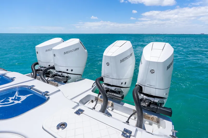 Slide: The Image of Freeman 43 boat with three Mercury outboard engines on turquoise ocean, 2025 model. - 38