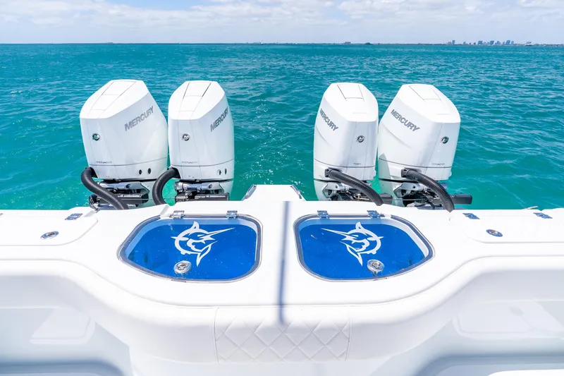 Slide: The Image of Four Mercury outboard engines on a 2025 Freeman 43 boat, cruising in clear blue waters. - 39