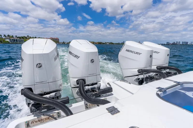 Slide: The Image of Freeman 43 boat with four Mercury outboard engines cruising on blue water, 2025 model. - 40