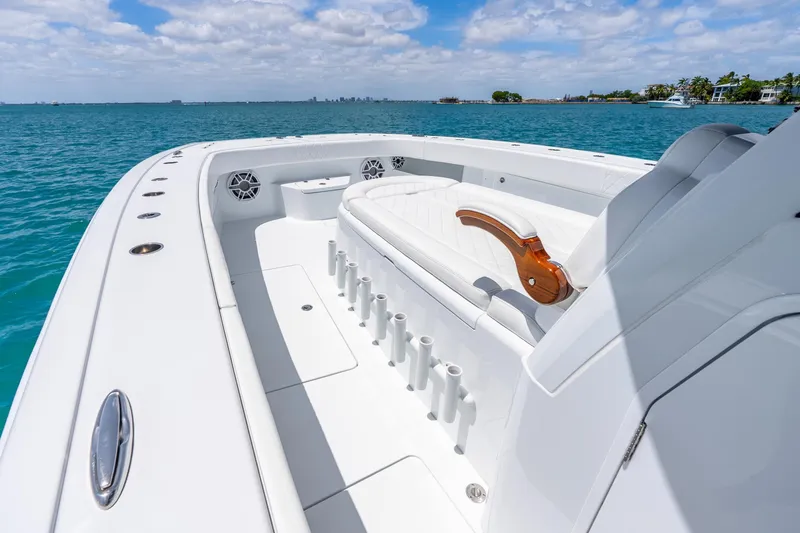 Slide: The Image of 2025 Freeman 43 boat with spacious deck, rod holders, and luxurious seating on open water. - 41