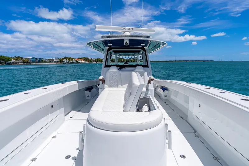 Slide: The Image of 2025 Freeman 43 boat on clear blue water, featuring sleek design and luxurious seating. - 43