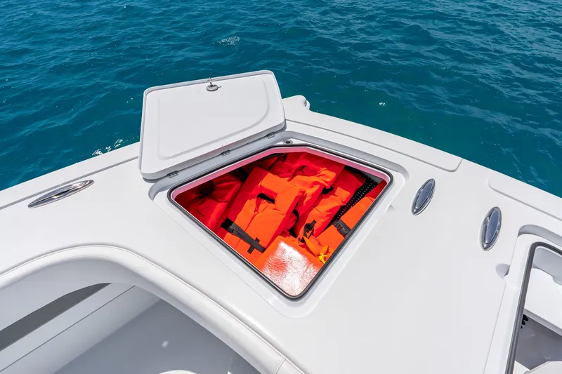 Slide: The Image of Open storage compartment on Freeman 43 boat, revealing orange life jackets against blue ocean backdrop. - 48