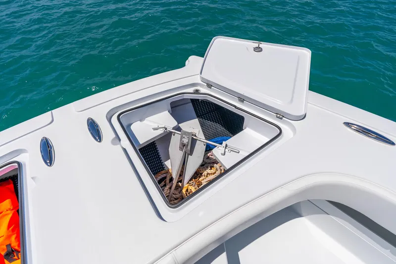 Slide: The Image of Open anchor compartment on 2025 Freeman 43 boat, floating on clear blue water. - 49