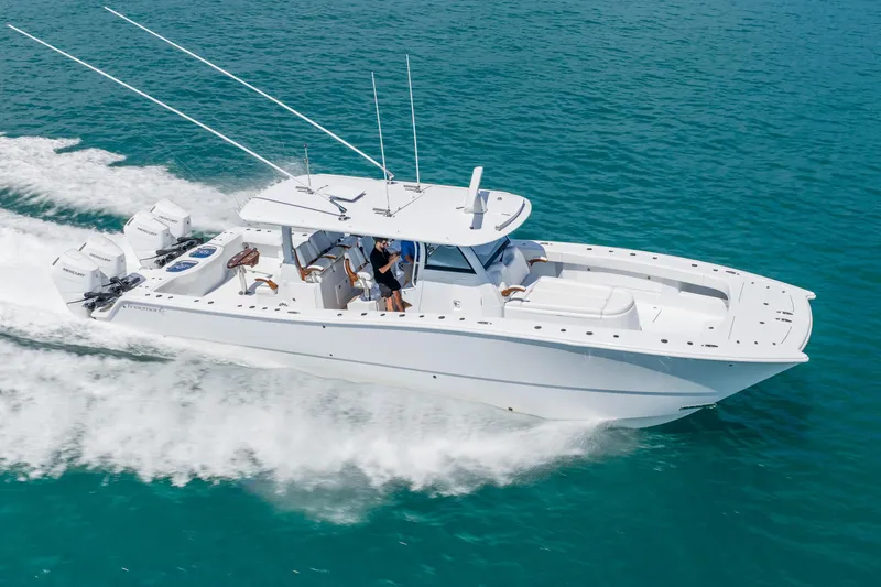 Slide: The Image of 2025 Freeman 43 boat cruising on clear blue water, showcasing sleek design and powerful engines. - 5