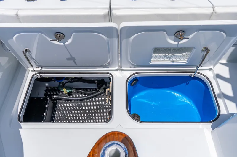 Slide: The Image of Open compartments on a 2025 Freeman 43 boat, showcasing storage and plumbing features. - 50