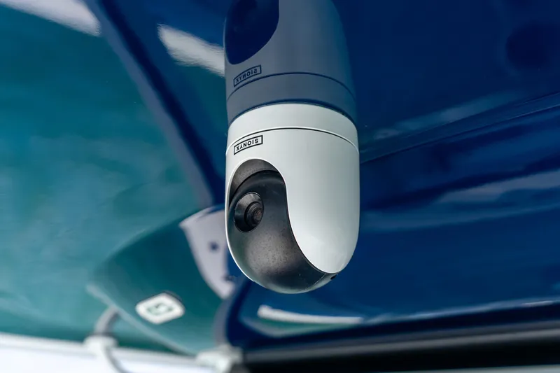 Slide: The Image of Security camera mounted on Freeman 43, 2025 model, with blue reflective surface. - 57