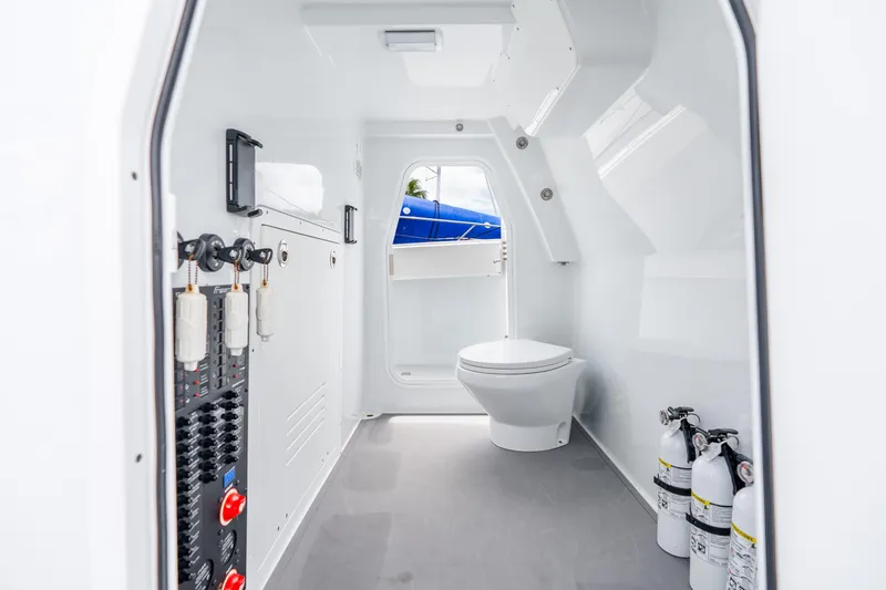 Slide: The Image of Interior of a 2025 Freeman 43 boat featuring a modern bathroom with fire extinguishers. - 58