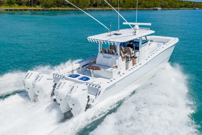 Slide: The Image of 2025 Freeman 43 boat cruising on clear blue water with powerful Mercury engines. - 7