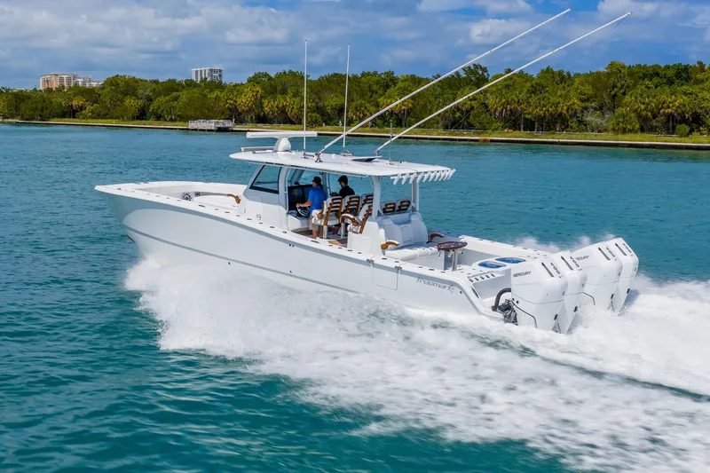 Slide: The Image of 2025 Freeman 43 boat cruising on clear blue water, showcasing powerful engines and sleek design. - 8