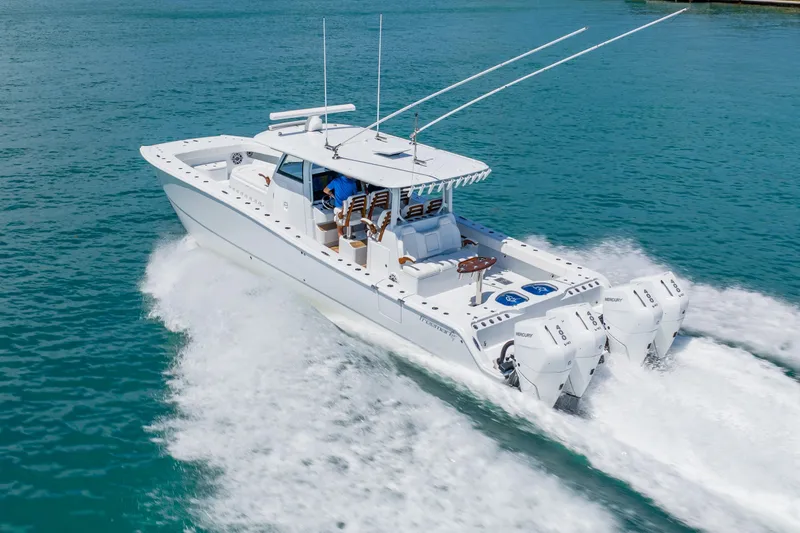 Slide: The Image of 2025 Freeman 43 boat cruising on clear blue water with powerful outboard engines. - 9