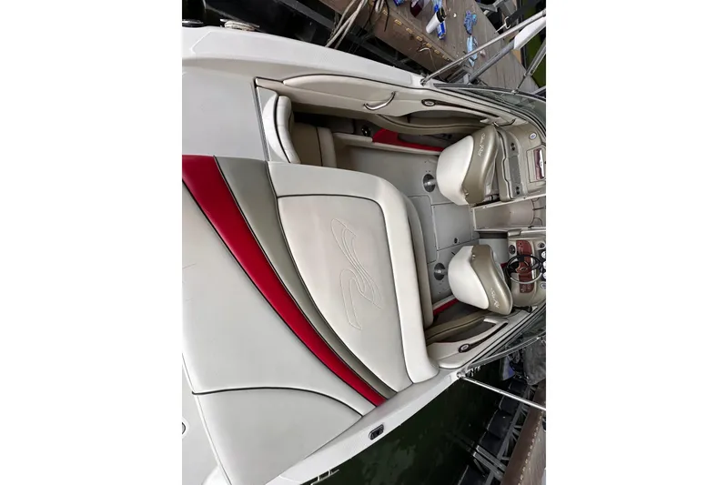 Slide: The Image of 2005 Sea Ray 200 Select boat interior with beige and red seating. - 11