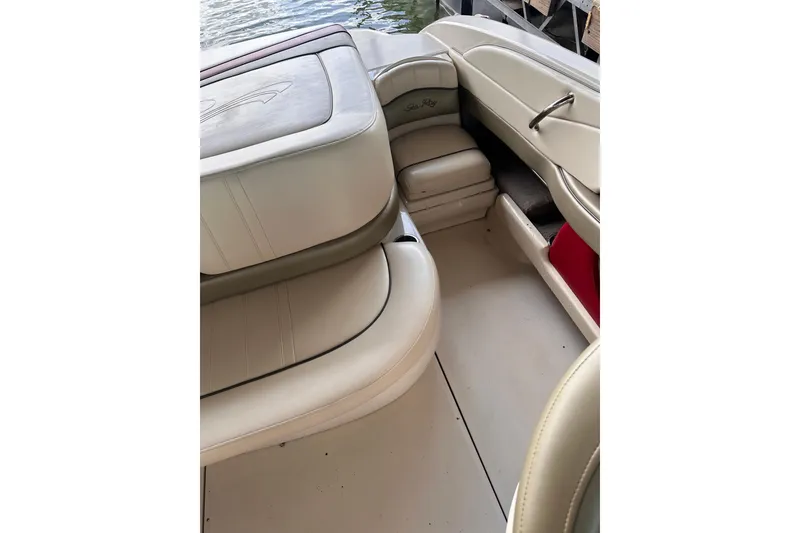 Slide: The Image of Interior of a 2005 Sea Ray 200 Select boat with beige seating and storage compartments. - 14
