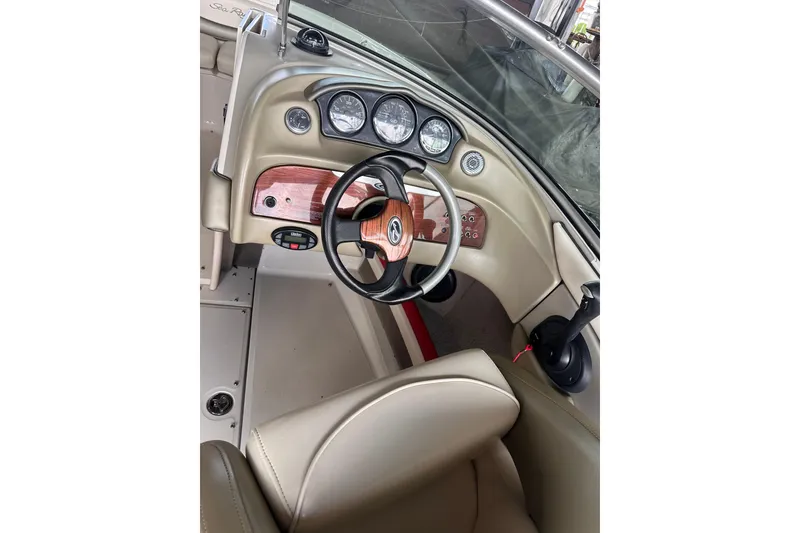 Slide: The Image of 2005 Sea Ray 200 Select boat dashboard with steering wheel and gauges. - 17